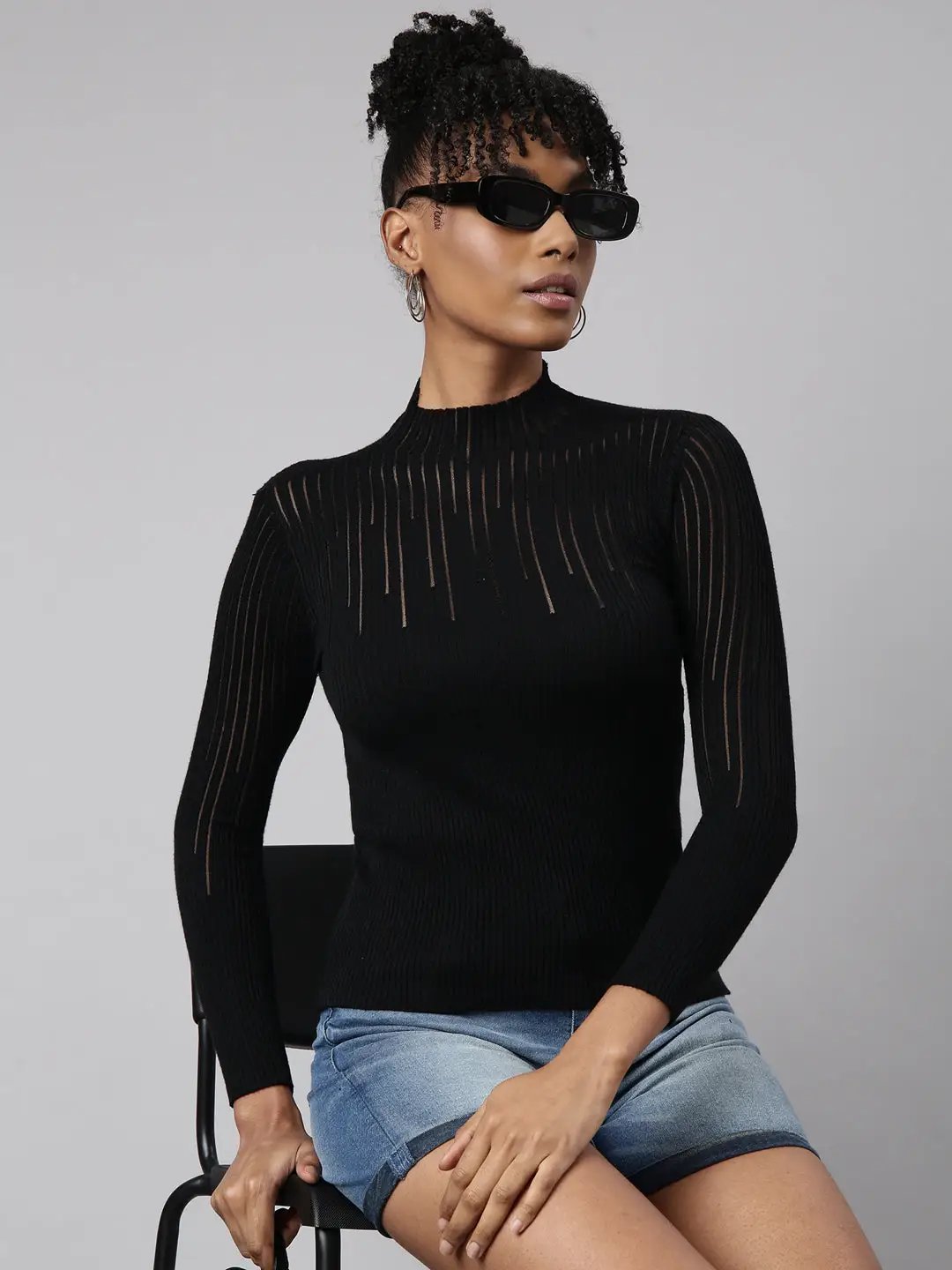 Woman wearing a black fitted high neck top